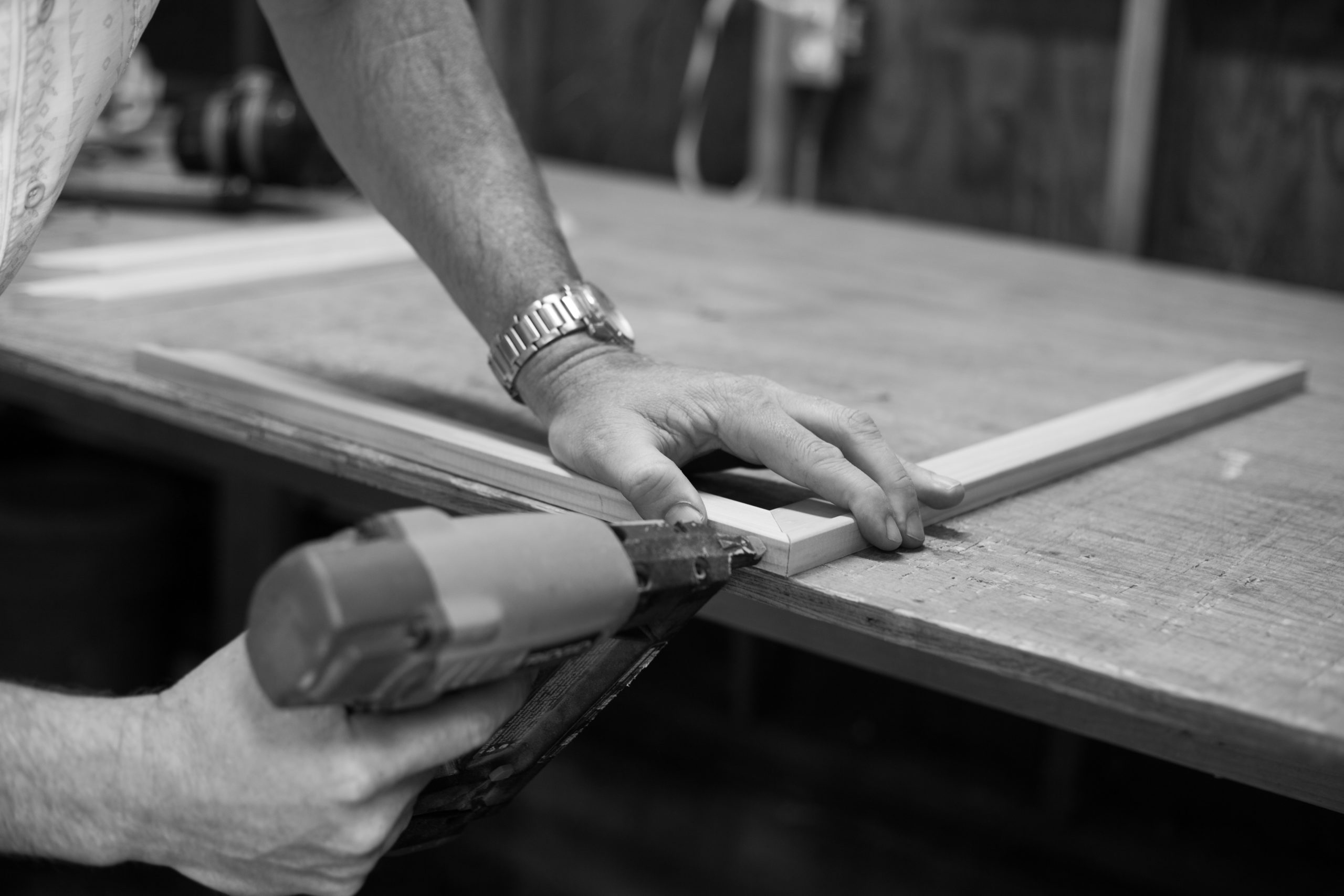 drilling a hole into wood on a workbench